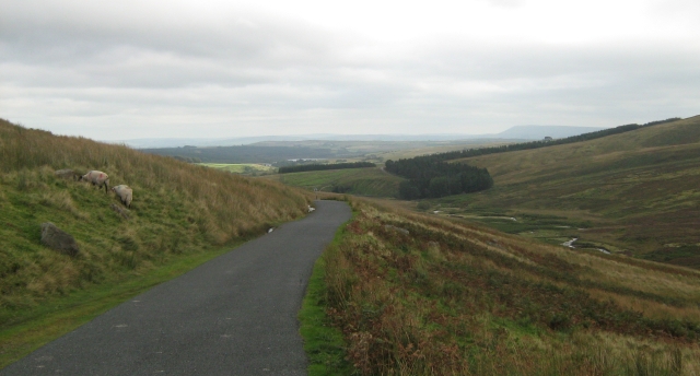 flatlands behind the hills seen from the road into slaidburn